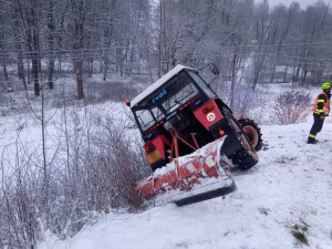 Hasiči vyprošťovali traktor na údržbu sněhu, hrozilo nebezpečí, že se zřítí z prudkého svahu