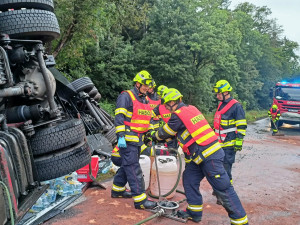 Převrácený mimo silnic skončil kamion převážející balené minerálky