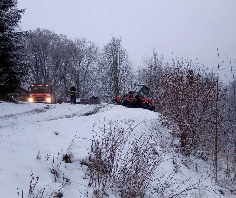 Hasiči vyprošťovali traktor na údržbu sněhu, hrozilo nebezpečí, že se zřítí z prudkého svahu