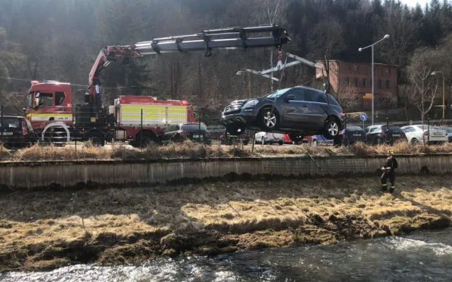 Mercedes prorazil plot a zřítil se z vysokého srázu až do koryta řeky