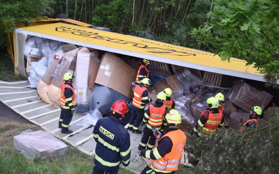 Nákladní automobil převážející nebezpečné látky skončil mimo vozovku převrácený na boku